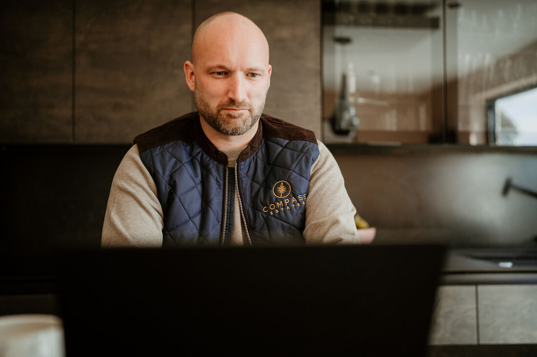 Duncan Ure, Compass Estates, working at a kitchen island